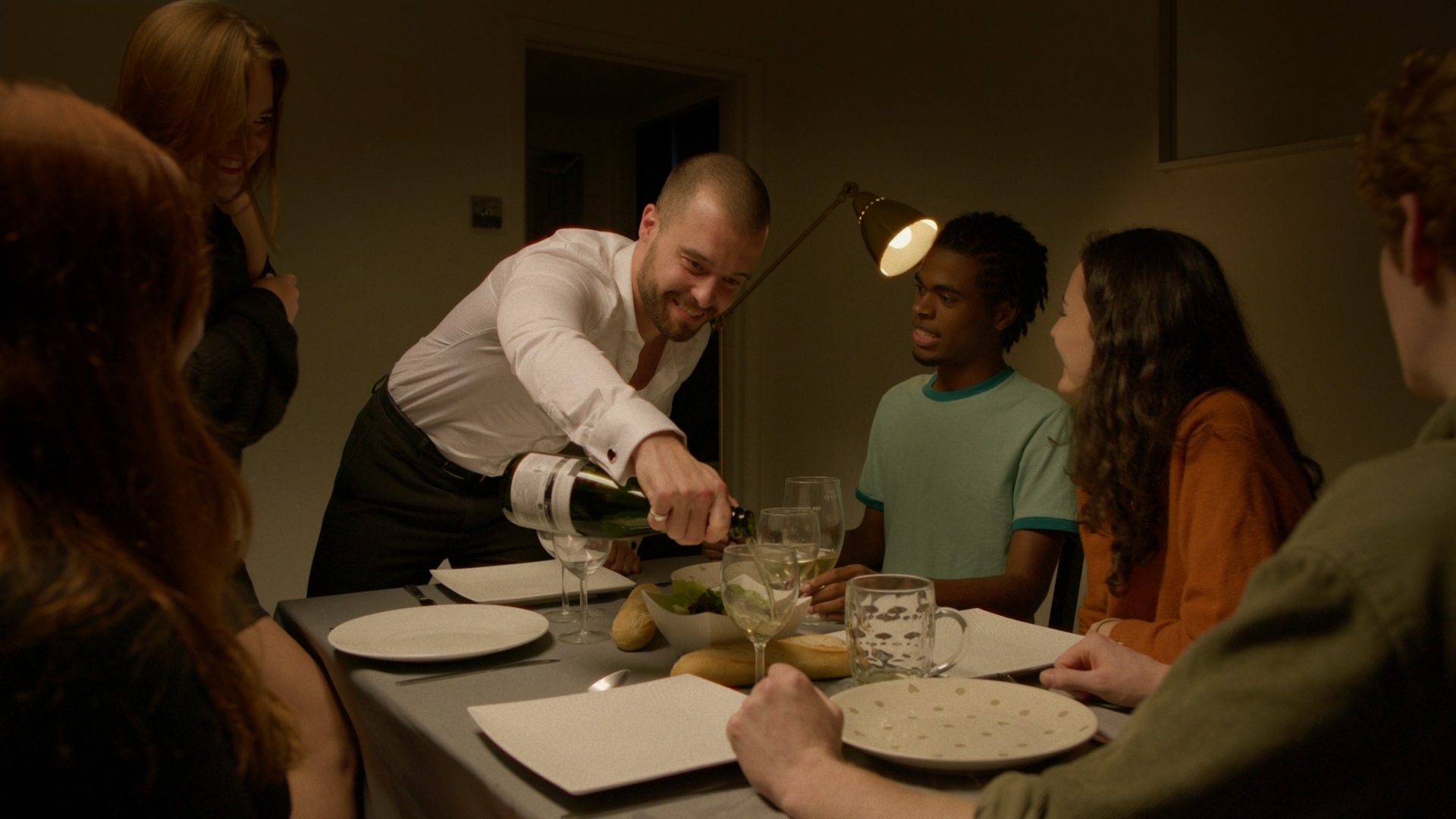 Group of friends having dinner, indoor, night time